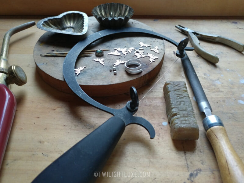 Still life of jeweler's hand tools and jewelry parts